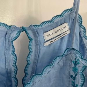 This is a blue embroidered babydoll dress that is perfect for summer!